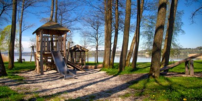 Campingplätze - Baden in natürlichen Gewässern - naturbelassener Spielplatz mit hohen Bäumen, direkt am See - Camping Stein